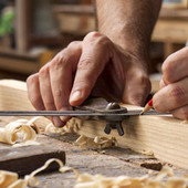 Artigiano al lavoro con mano che lavora il legno